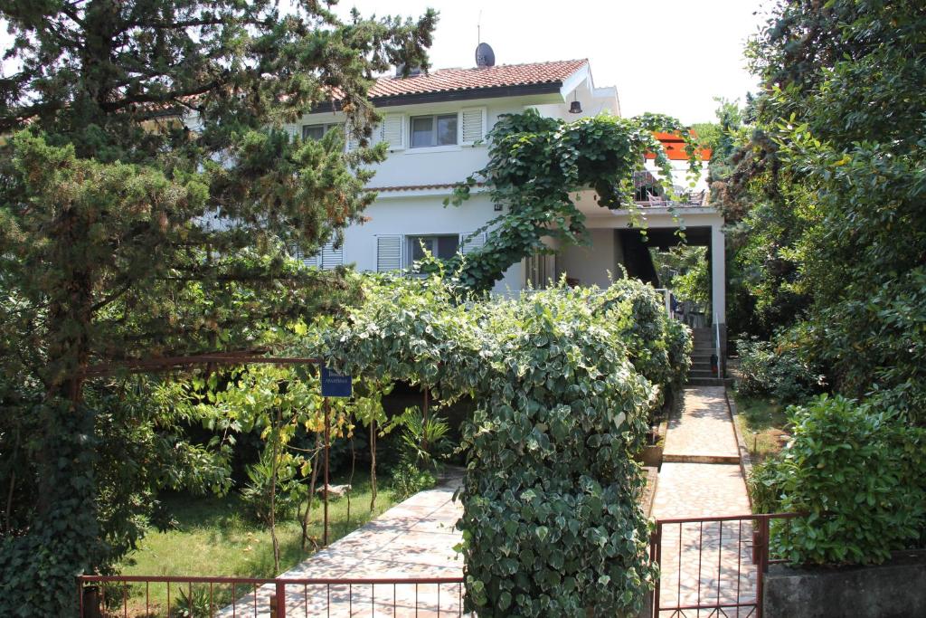 a house with a fence in front of a garden at Apartments by the sea Malinska (Krk) - 5290 in Vantačići