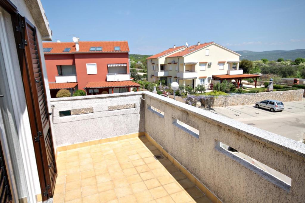 a balcony with a view of a street and buildings at Double Room Krk 5294b in Krk