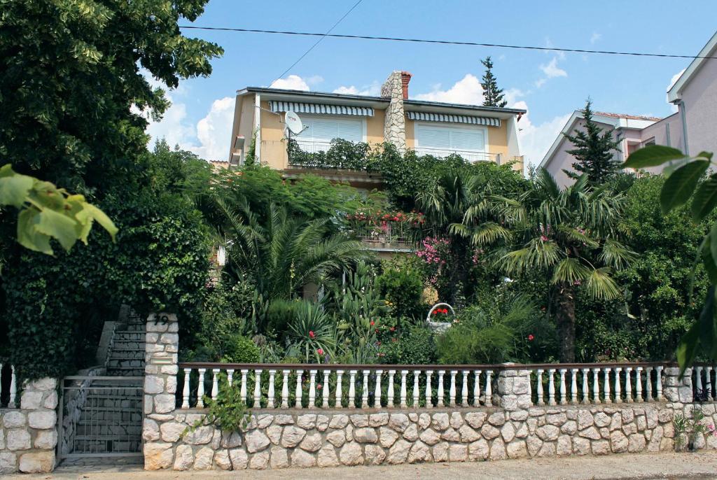 a house with a stone fence in front of it at Apartments and rooms by the sea Dramalj, Crikvenica - 5519 in Dramalj