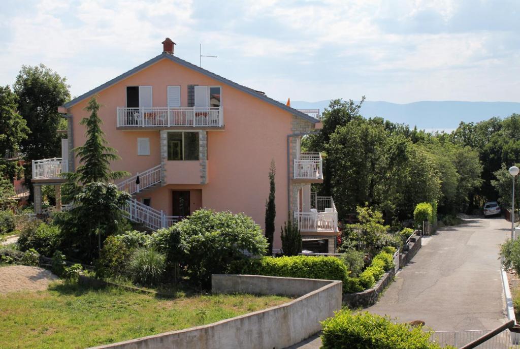 a house on a hill with a driveway at Apartments and rooms with parking space Njivice, Krk - 5398 in Njivice