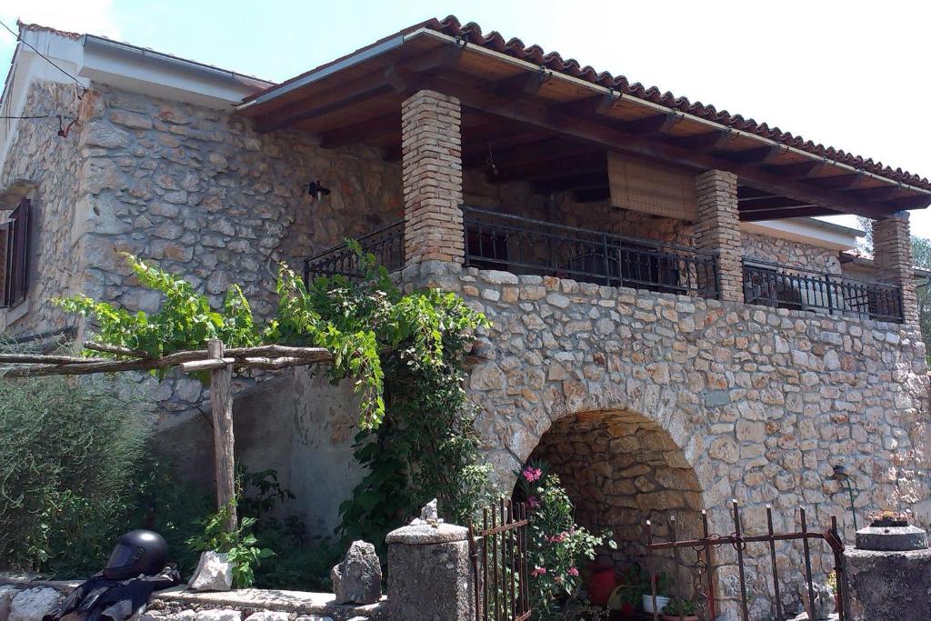 a stone building with an archway in front of it at Apartments with a parking space Zupanje, Krk - 5307 in Županje