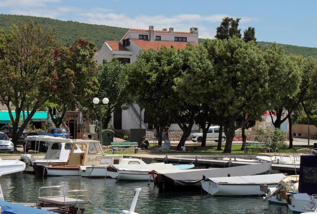 a group of boats are docked in a marina at Apartments by the sea Punat, Krk - 5328 in Punat