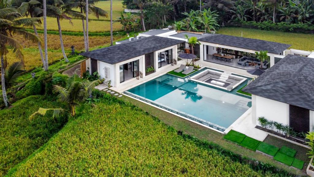 an aerial view of a house with a swimming pool at Villa Manga by BaliSuperHost in Ubud