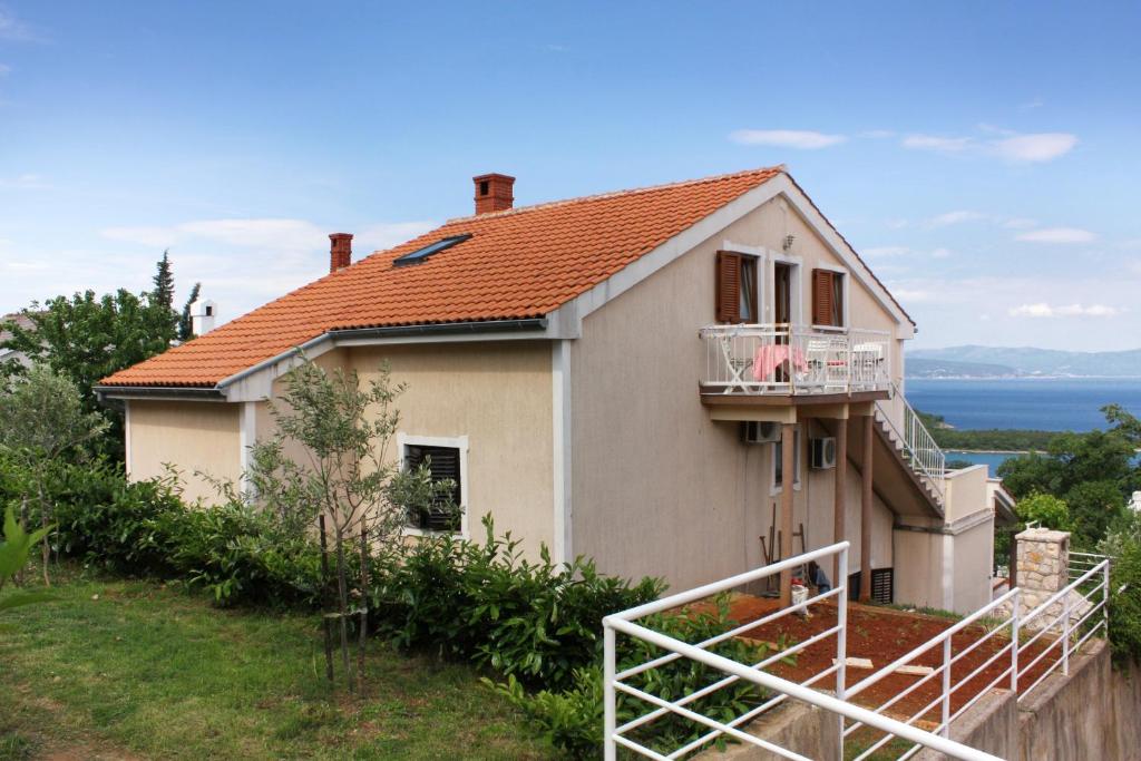 a house on the side of a hill at Apartment Njivice 5362b in Njivice