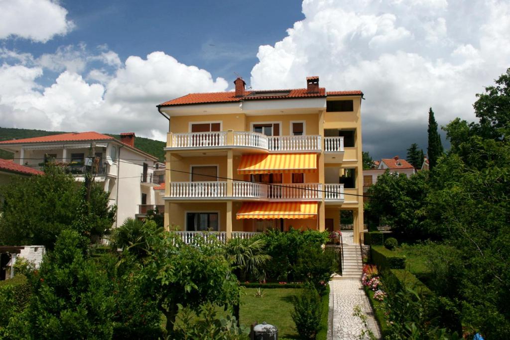 a large yellow building with a balcony on top of it at Apartments with a parking space Selce, Crikvenica - 5513 in Selce