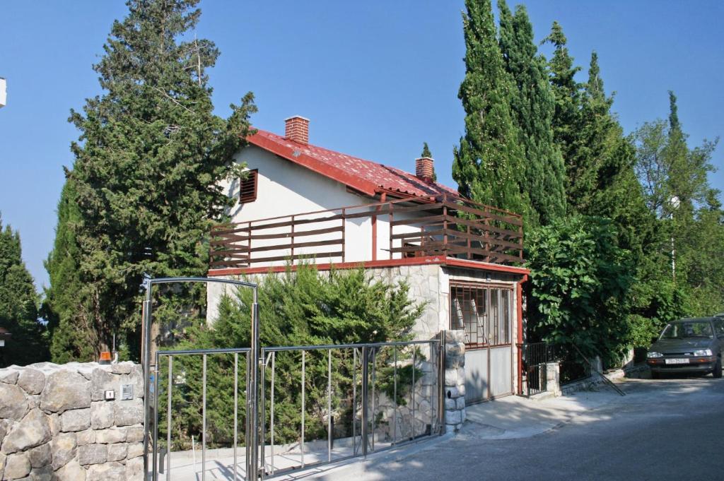 a house with a fence in front of it at Apartments with a parking space Selce, Crikvenica - 5531 in Selce