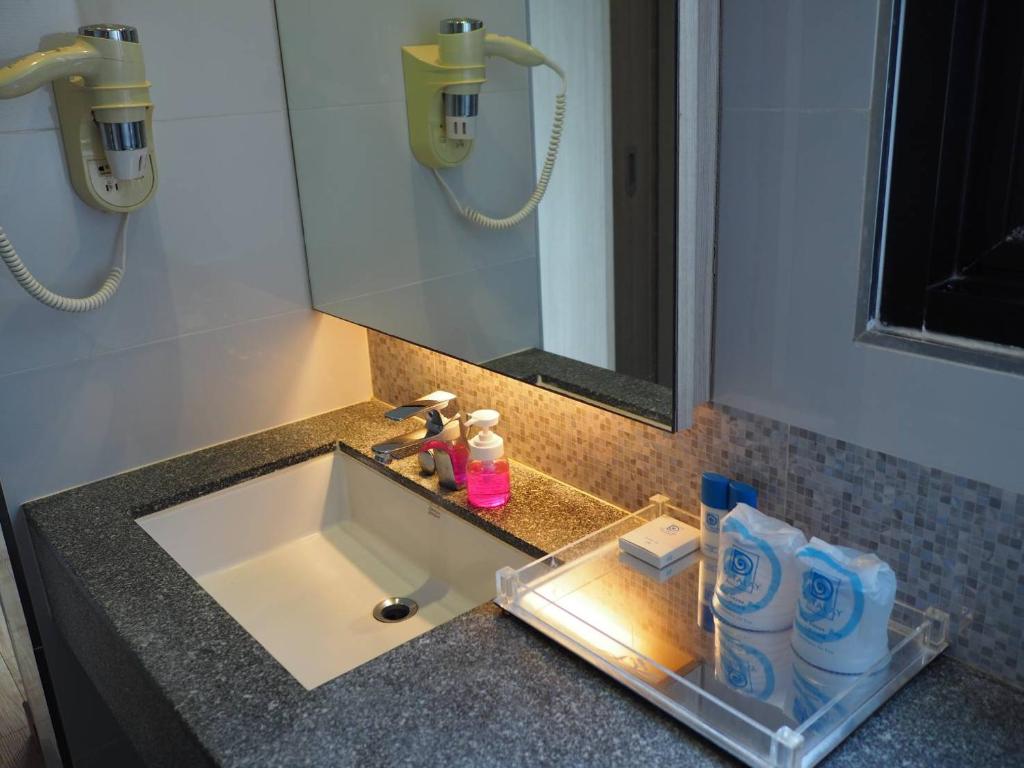 a bathroom counter with a sink and a mirror at Du Talay Hotel Koh Chang in Ko Chang