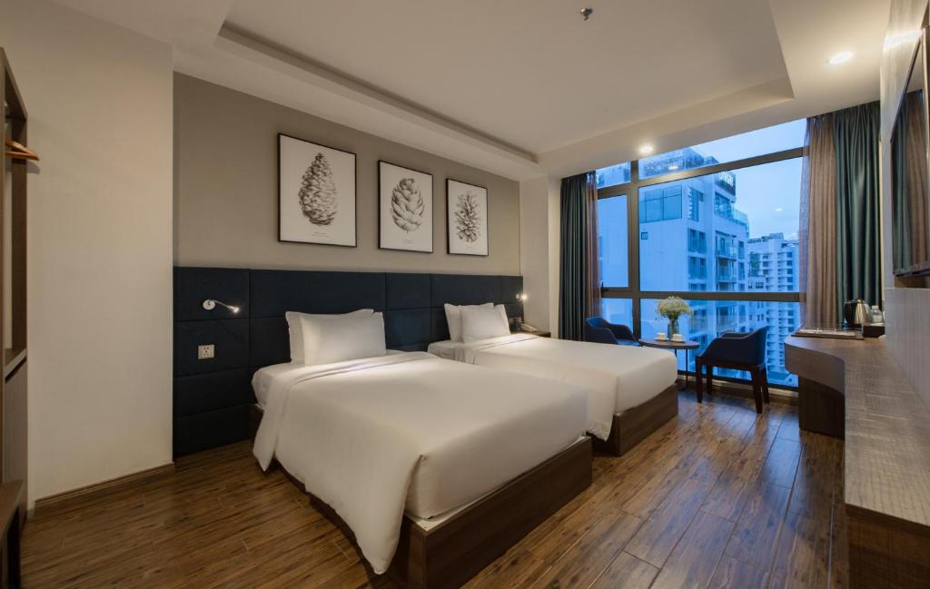 Giường trong phòng chung tại Aaron Hotel