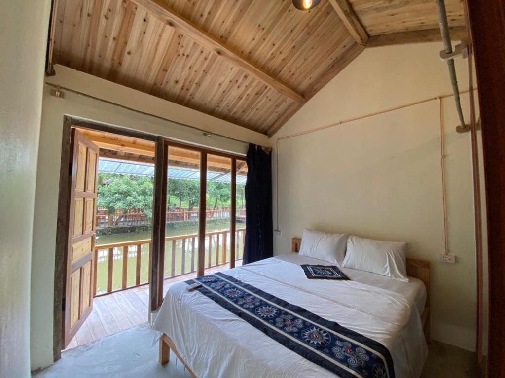 Na Hang的住宿－Bong Bang homestay 2，一间卧室设有一张床和一个大窗户