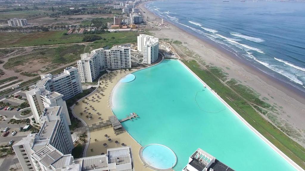 an aerial view of a beach with a large pool at Laguna del mar La Serena in La Serena