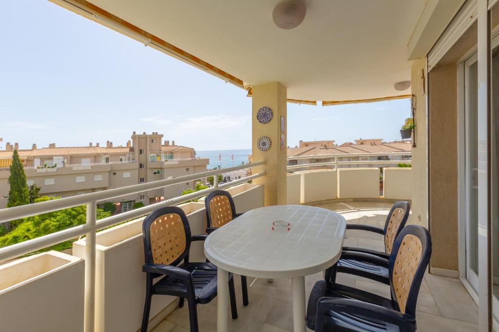 a balcony with a table and chairs and a view at Carihuela beach in Torremolinos