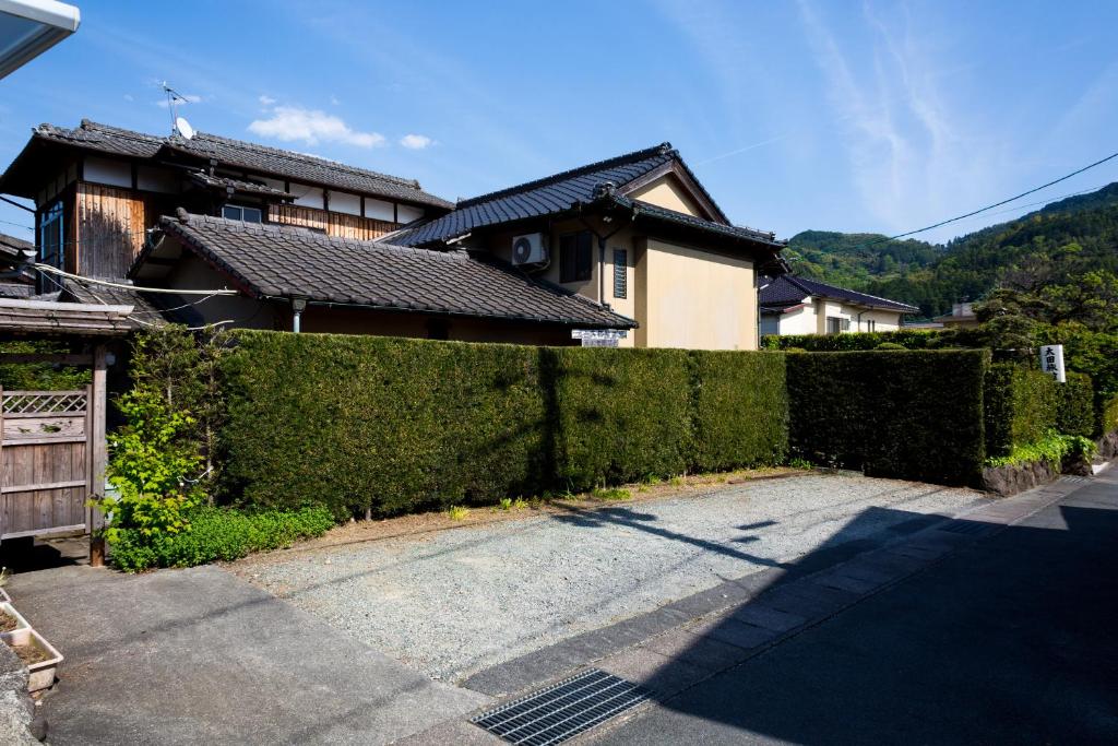 a hedge fence in front of a house at ootaryokan in Kuroki