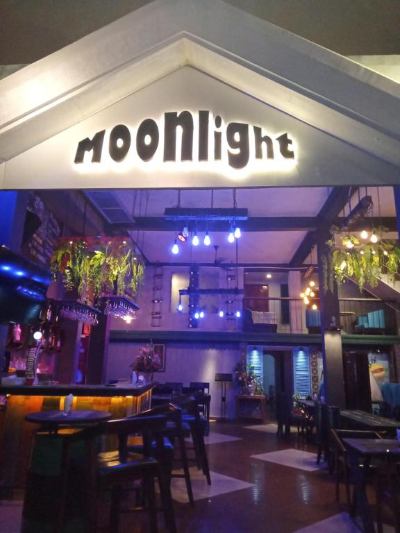 a restaurant with tables and chairs and a sign that reads moorigun at Moonlight Villa in Phnom Penh