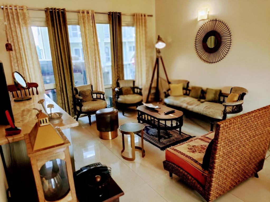 a living room with couches and chairs at Luxurious Affordable Serviced Apt PariChowk/ExpoMart/Expressway Noida in Greater Noida