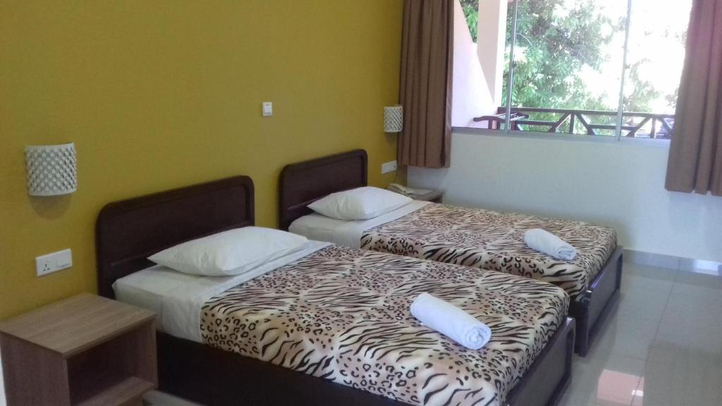Postel nebo postele na pokoji v ubytování Seaside Travellers Inn