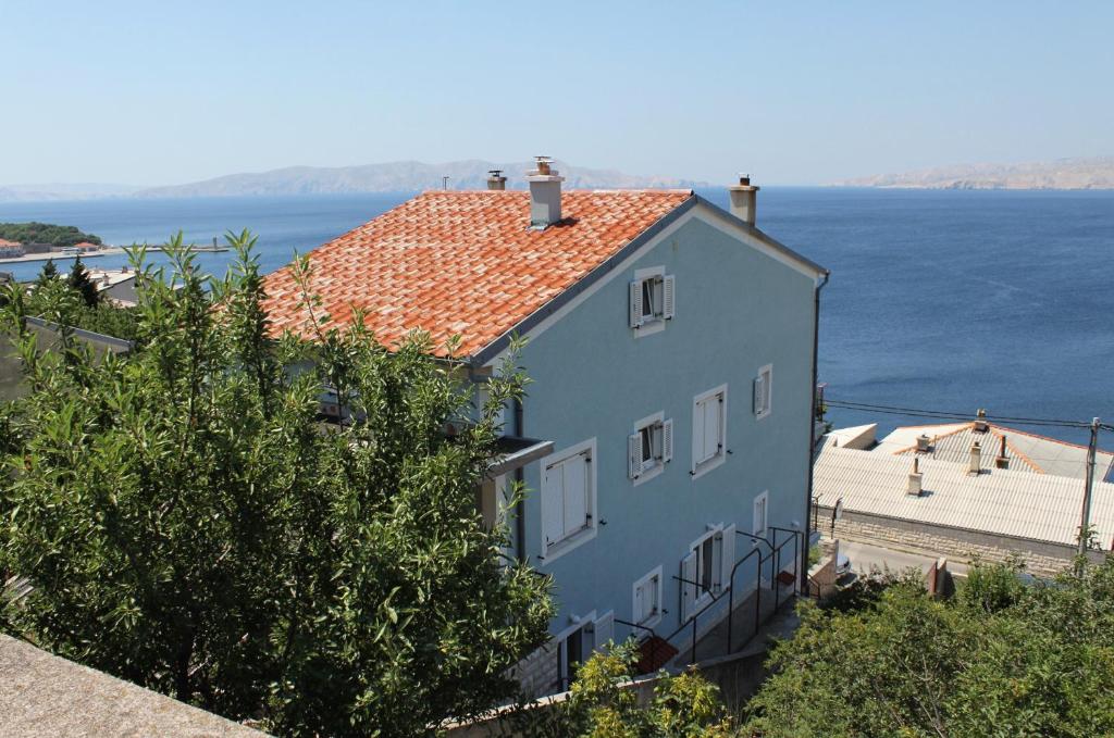 a blue house with a view of the water at Apartments and rooms with WiFi Senj - 5560 in Senj