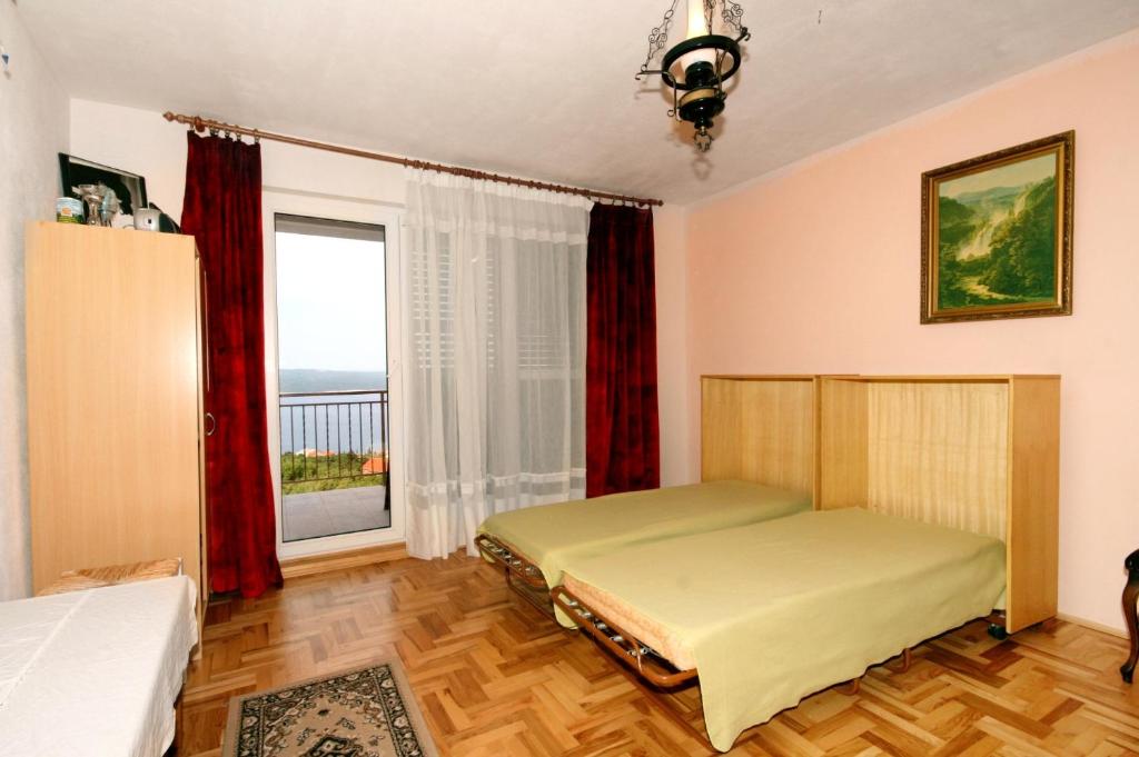 um quarto com 2 camas e uma janela em Apartments for families with children Crikvenica - 5554 em Crikvenica