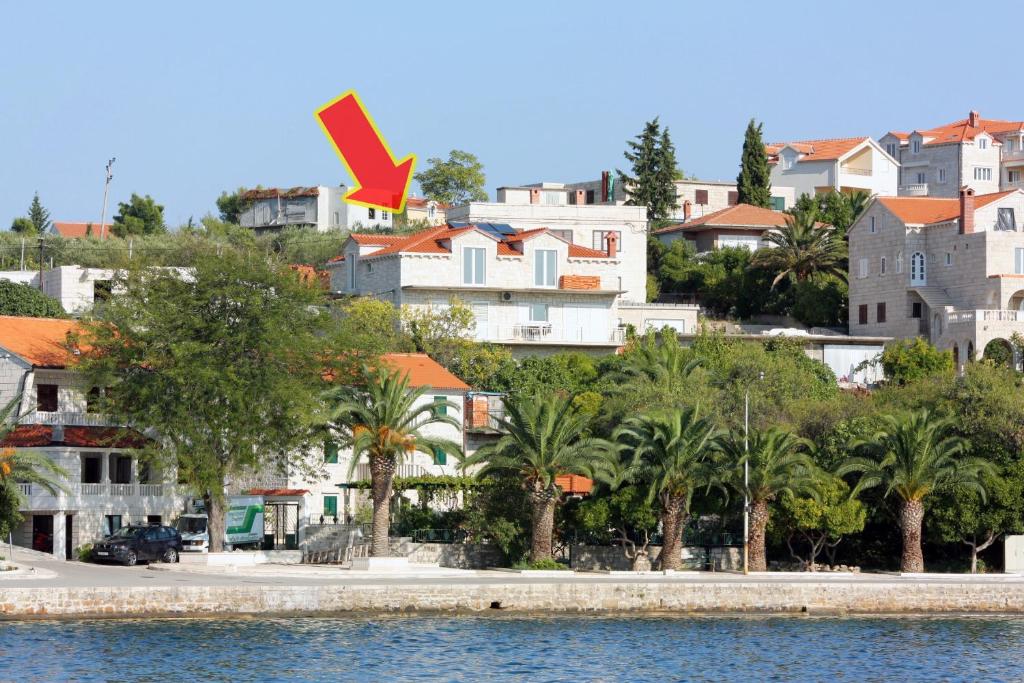 a view of a city with palm trees and buildings at Apartments by the sea Sumartin, Brac - 5620 in Sumartin