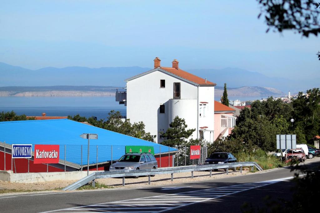 a road with cars parked on the side of a building at Apartments with a parking space Selce, Crikvenica - 5477 in Selce
