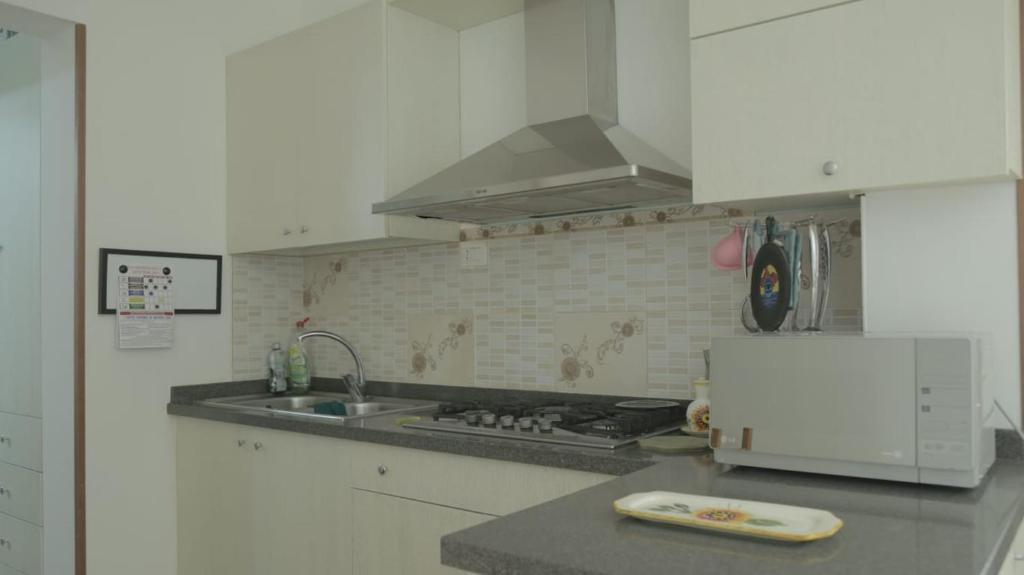 a white kitchen with a sink and a stove at Casa Stefano Lecce in Lecce