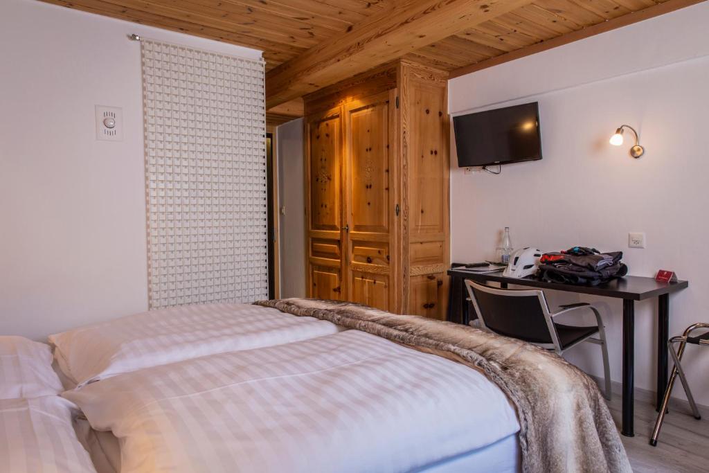 Voodi või voodid majutusasutuse Hôtel Alpina - Swiss Ski & Bike Lodge Grimentz toas