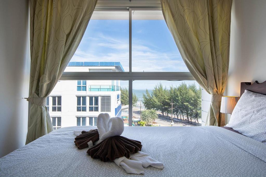 a bedroom with a bed with a large window at Avatara A condominium B61 with sea view in Mae Pim