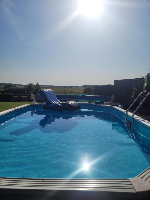 a large swimming pool with a slide at ŻurawZdory 107 in Zdory