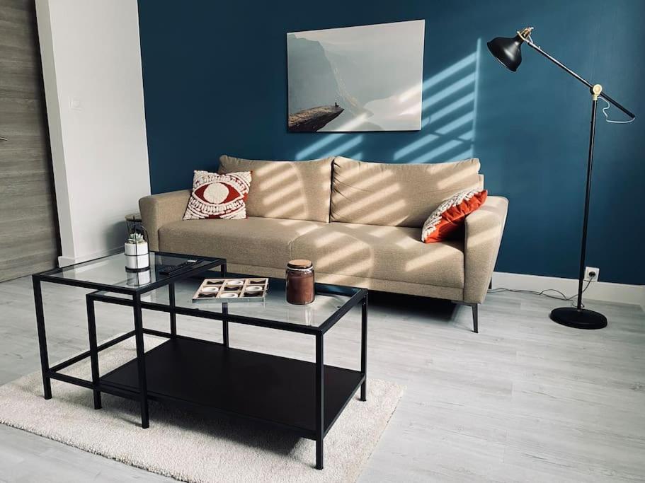 a living room with a couch and a table at Appartement Duplex La Cambu'z Le Portel Plage in Le Portel