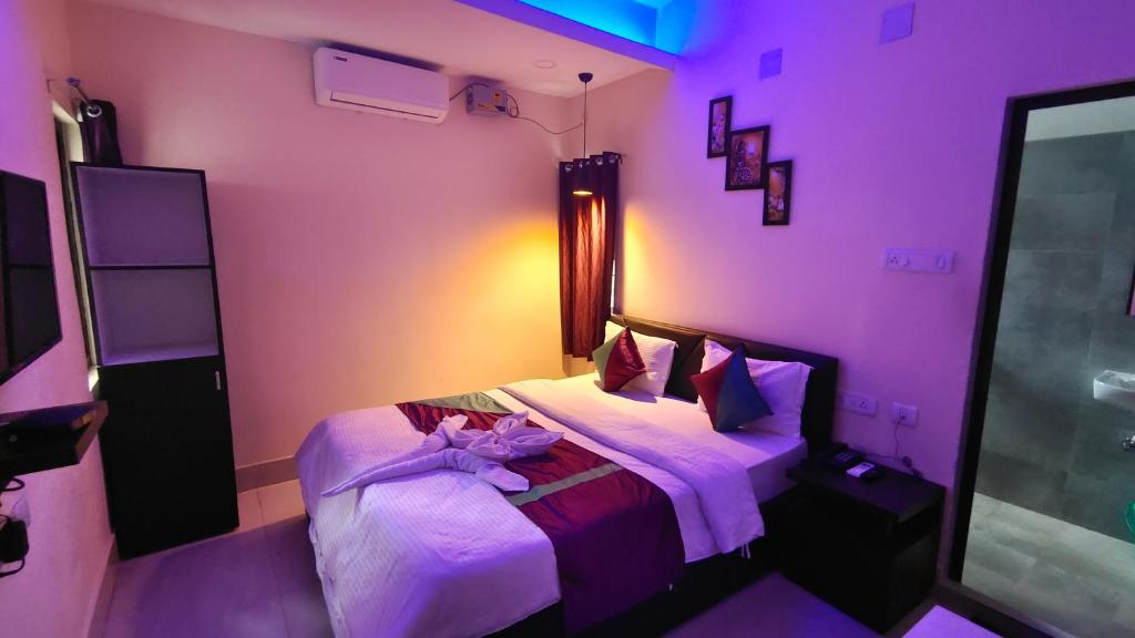 a bedroom with a purple room with a bed at THE GREENSTAR INN PREMIUM in Bhubaneshwar