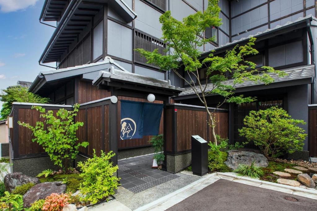an apartment building with a gate and a garden at Rinn Gion Yasaka in Kyoto