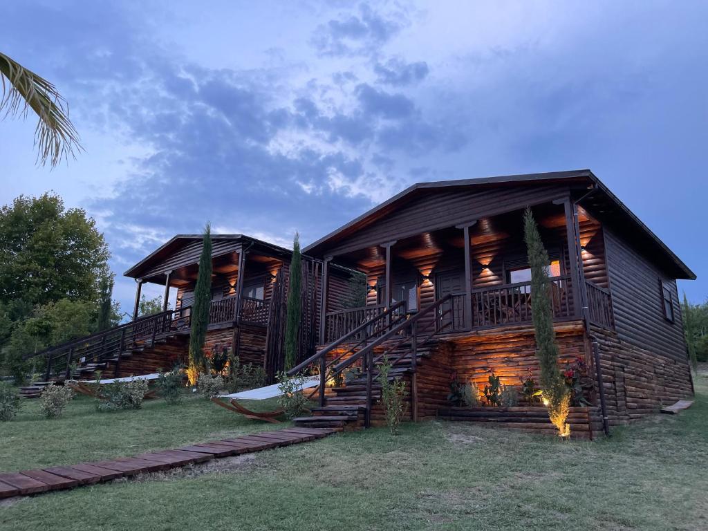 a log cabin with two decks and a staircase at Luxury Wooden Villas in Makrygialos