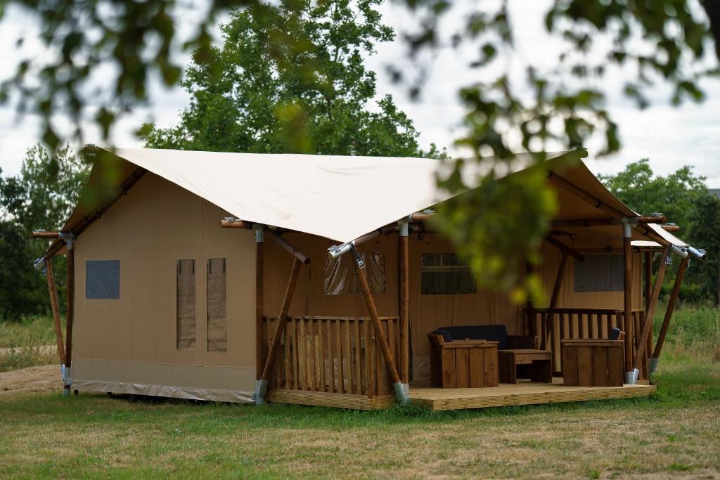 a small house with a white cover on top at LE LODGE DU DOMAINE in Saint-Hilaire-en-Morvan