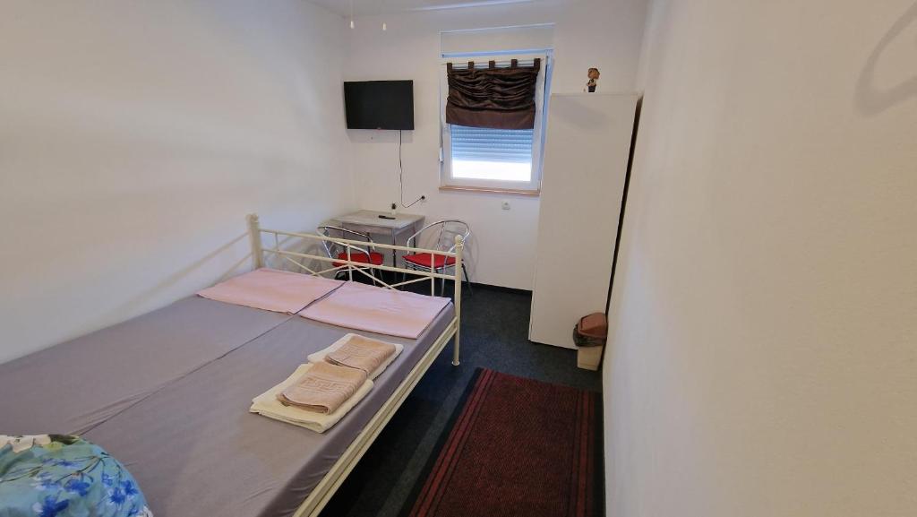 a small room with a bed and a window at Neiras Apartments Blagaj in Blagaj