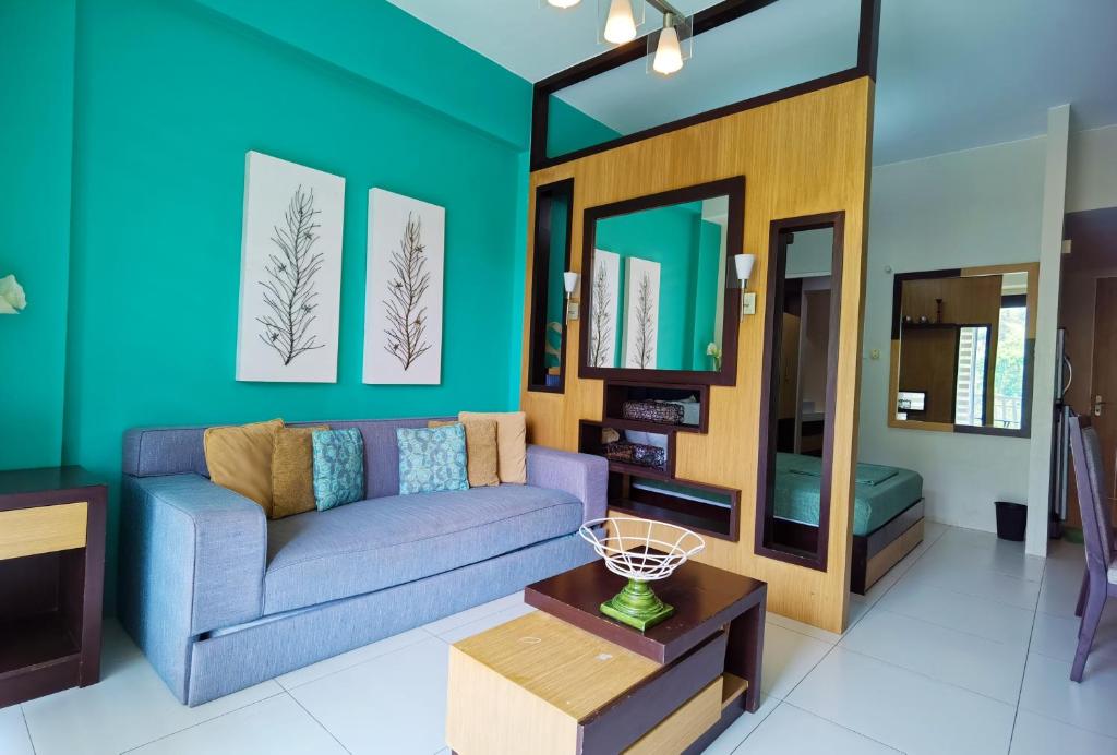 a living room with a couch and a table at Miranda 504B 1BR at Pico de Loro by Raquel's Place in Nasugbu