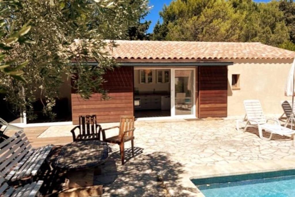 a house with a pool and chairs next to a building at PETIT TERME - Piscine - CLIM - Parking in Les Angles Gard