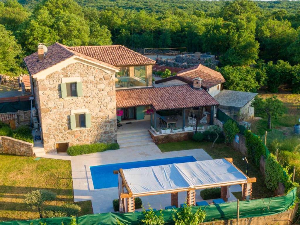an aerial view of a house with a tennis court at Villa Campiello heated pool in Vrbnik
