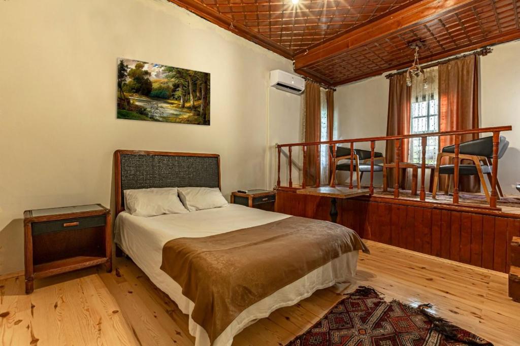 a bedroom with a bed and a balcony at Sarı Konak in Antalya