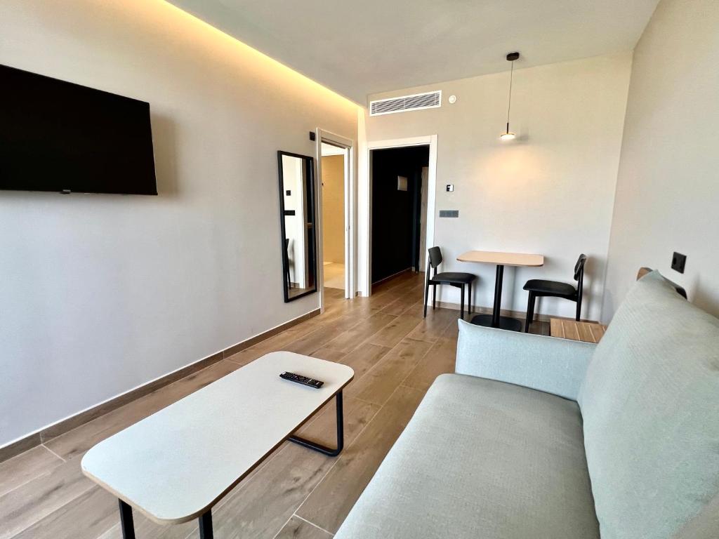 a living room with a couch and a table at Hotel Primavera Park in Benidorm