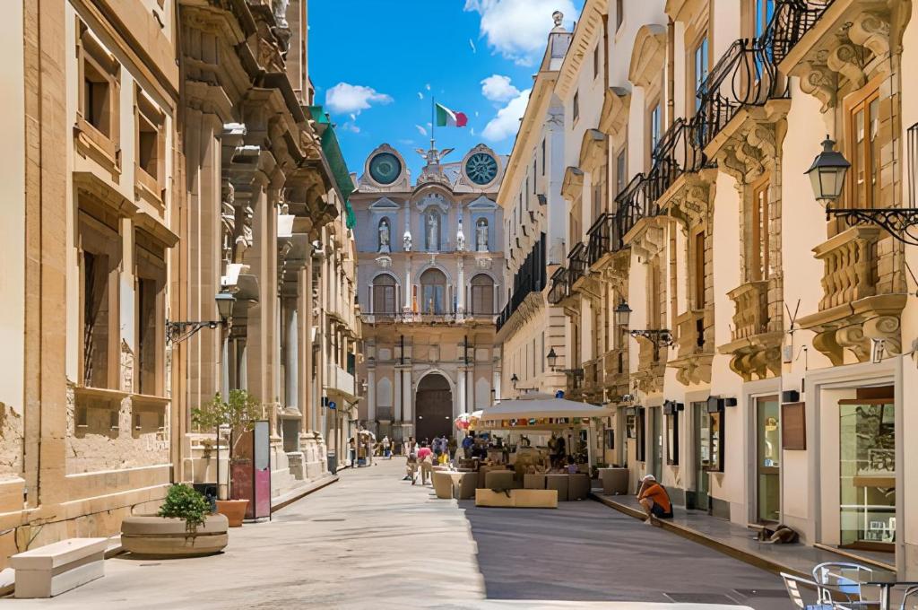 an empty street in a city with buildings at A due passi dal mare in Trapani