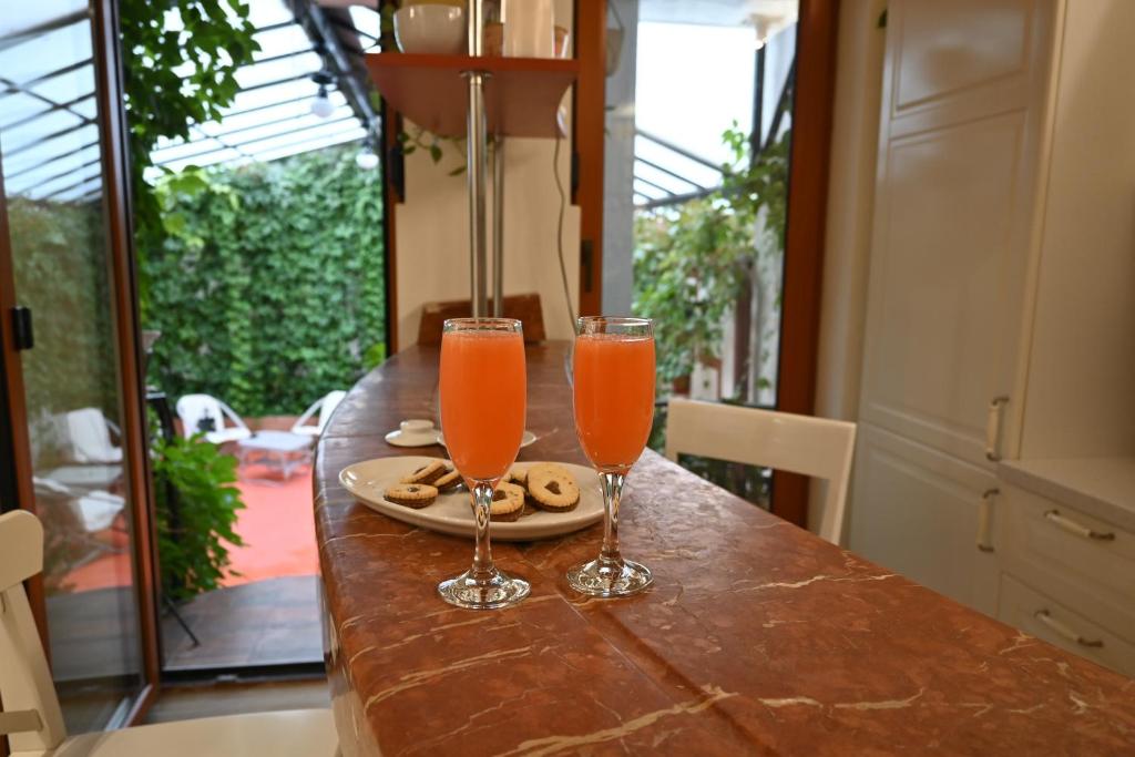 two glasses of orange juice sitting on a table at Villa Magicland in Sofia