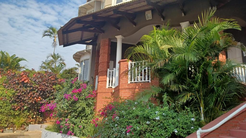 a brick house with trees and flowers in front of it at The Good Life in Durban