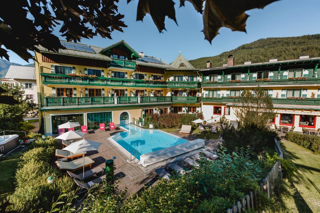 a hotel with a swimming pool and a resort at Hotel Sommerhof in Gosau
