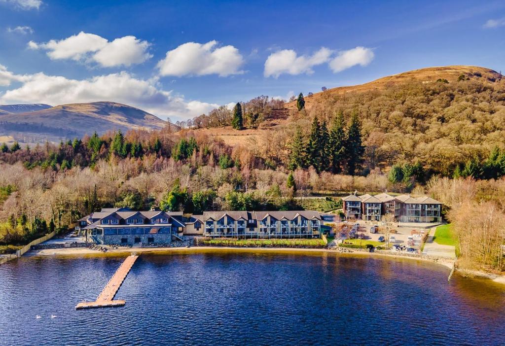 an aerial view of a resort on a lake at The Lodge On Loch Lomond Hotel in Luss