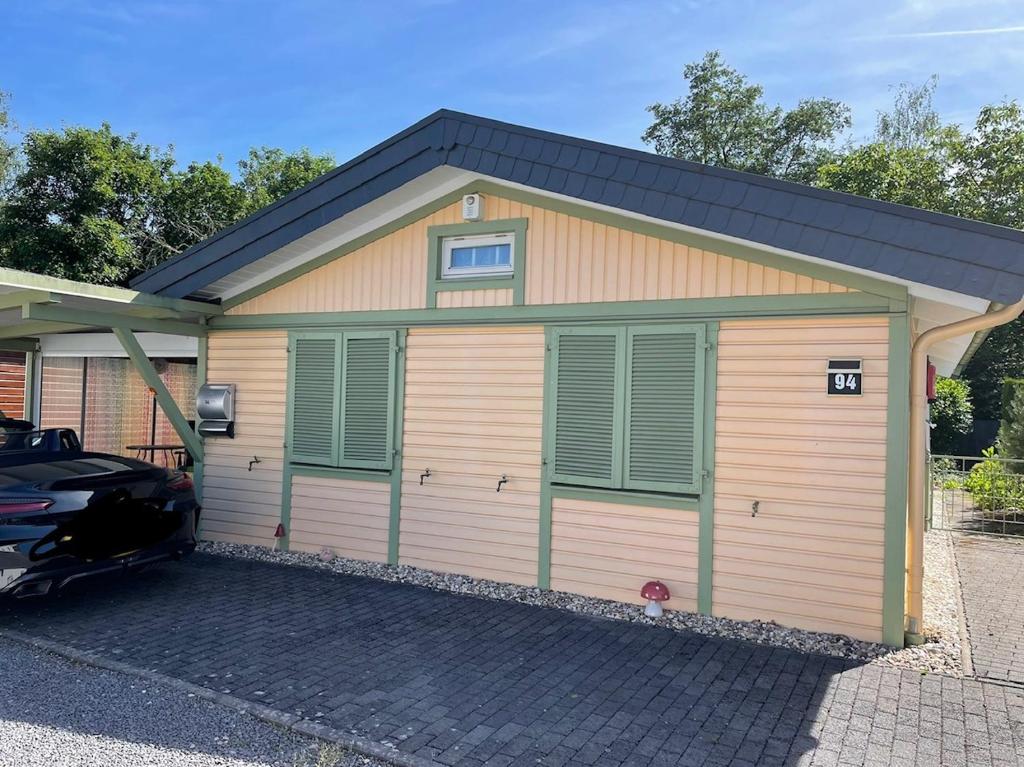 a garage with two cars parked in front of it at Majo in Koblenz