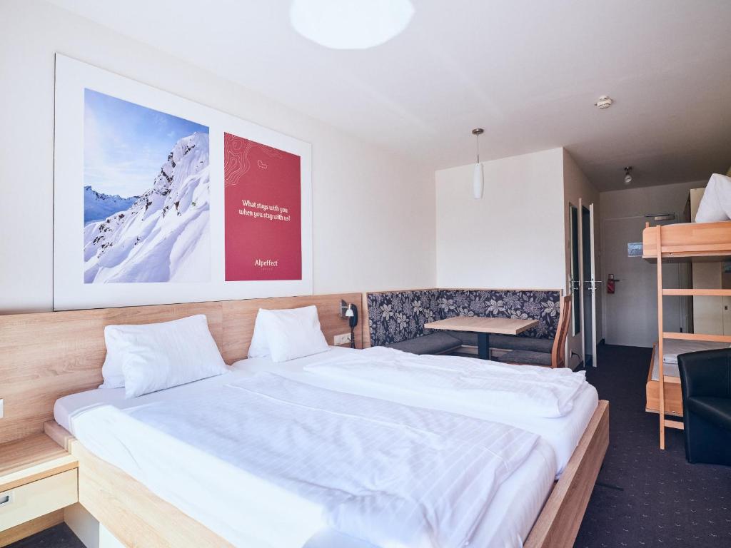 Postel nebo postele na pokoji v ubytování Hotel Planai by Alpeffect Hotels