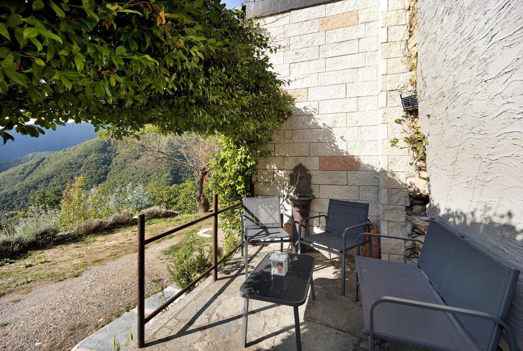 a group of chairs sitting on the side of a building at Ca' Kira in Molini di Triora
