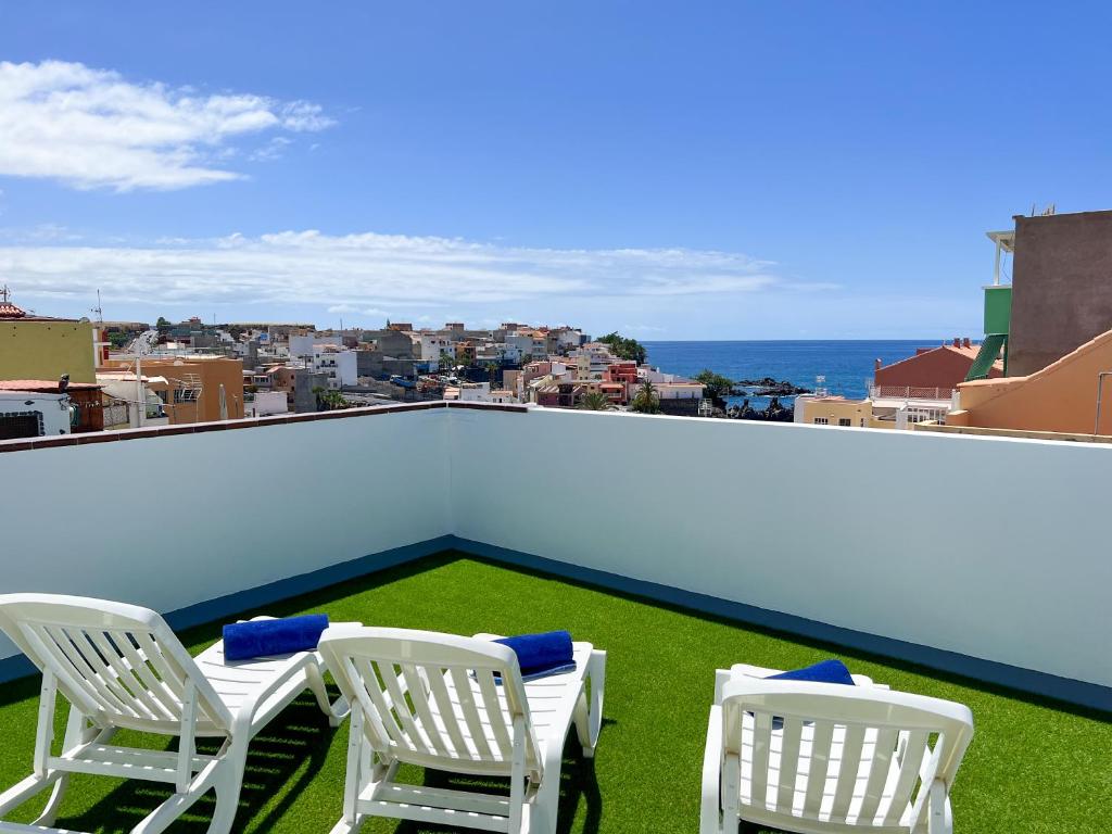 two white chairs sitting on top of a roof at La Cala de Alcalá Luxury in Alcalá