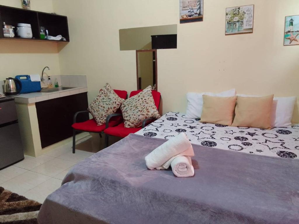 1 dormitorio con 1 cama con toallas en Affordable Staycation along Ortigas Extension, en Cainta