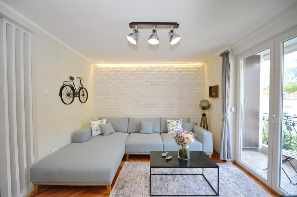 a living room with a couch and a table at The Nest - Urban Family place in Kotor