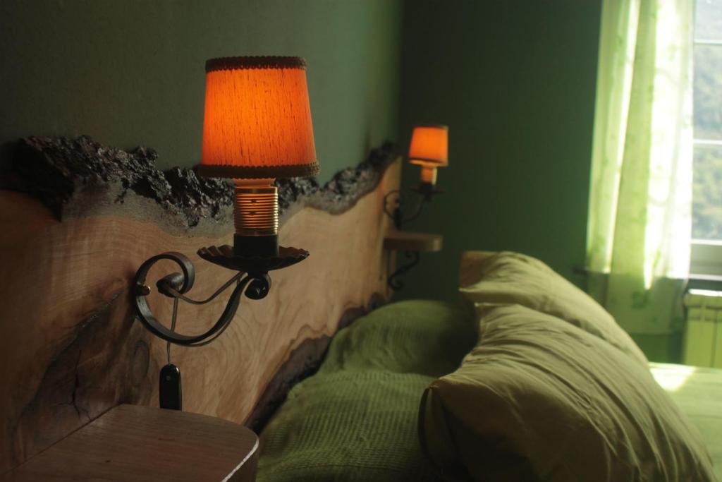 a lamp next to a couch in a room at B&B Il Cedro in Genoa